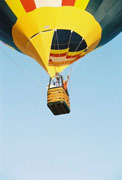 Waving as the balloon soars skyward.